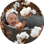 Girl in bucket in cotton field